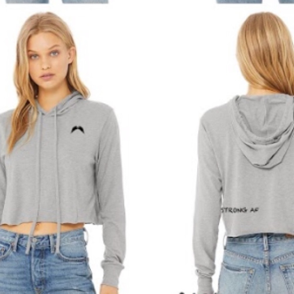Female workout crop hoodie with strong statement